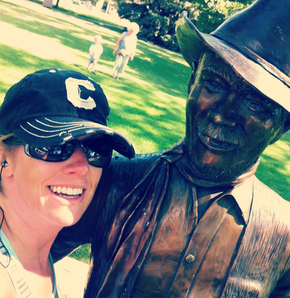 posing with a statue